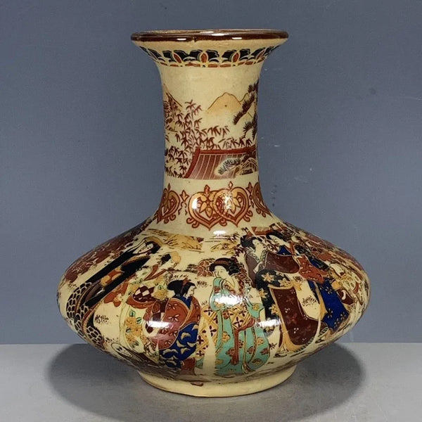 Decorative ceramic vase with intricate designs on a gray background