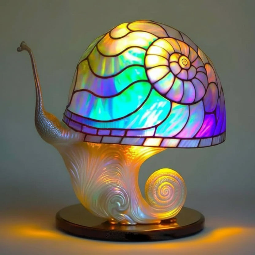 Multicoloured stained resin snail mushroom table lamp glowing in warm ambient light