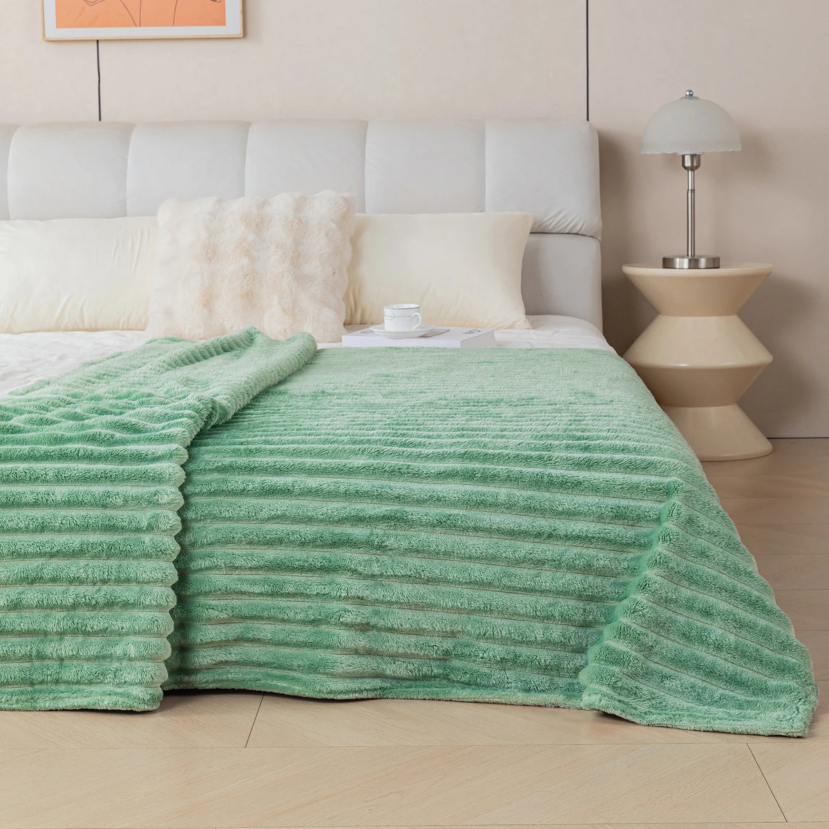 Green textured blanket on a bed in a bedroom setting