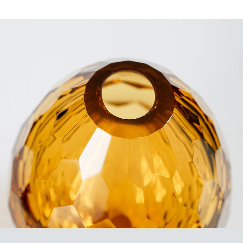 Top opening detail of an amber sculpted glass vase