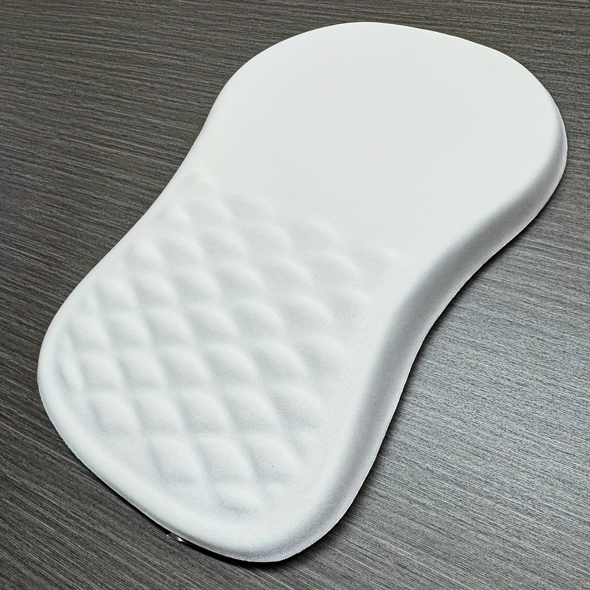 White rubber mouse mat on a grey surface