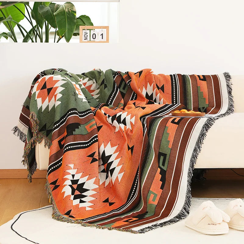 Teal and orange Indian style woven blanket featuring a large central geometric sunburst.