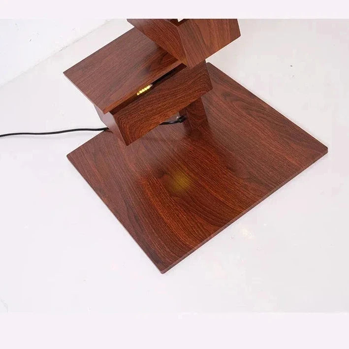 Close-up of rosewood grain lamp base showing square platform and lower geometric structure