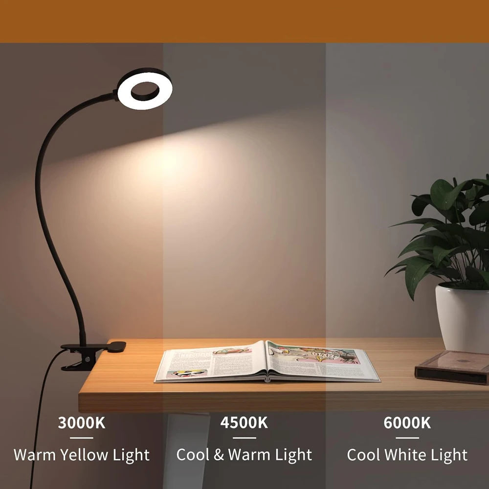 Desk lamp with 3 color modes on a wooden surface with a plant and magazine.