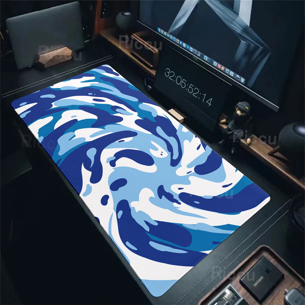Blue and white camouflage mouse pad on a desk with computer equipment.