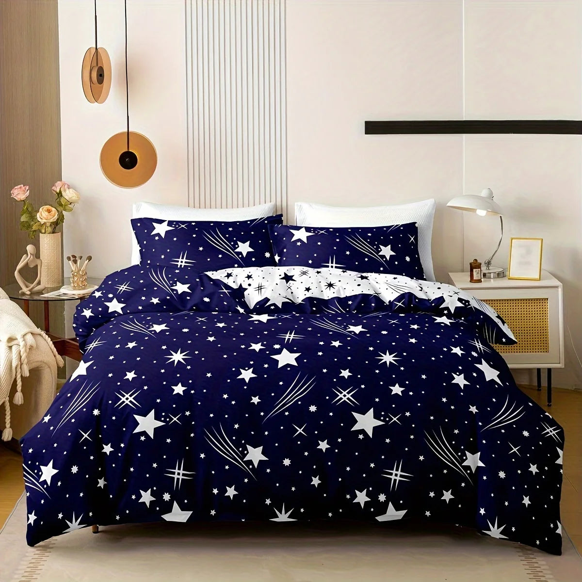 Navy blue bedding set with star pattern on a bed in a bedroom.