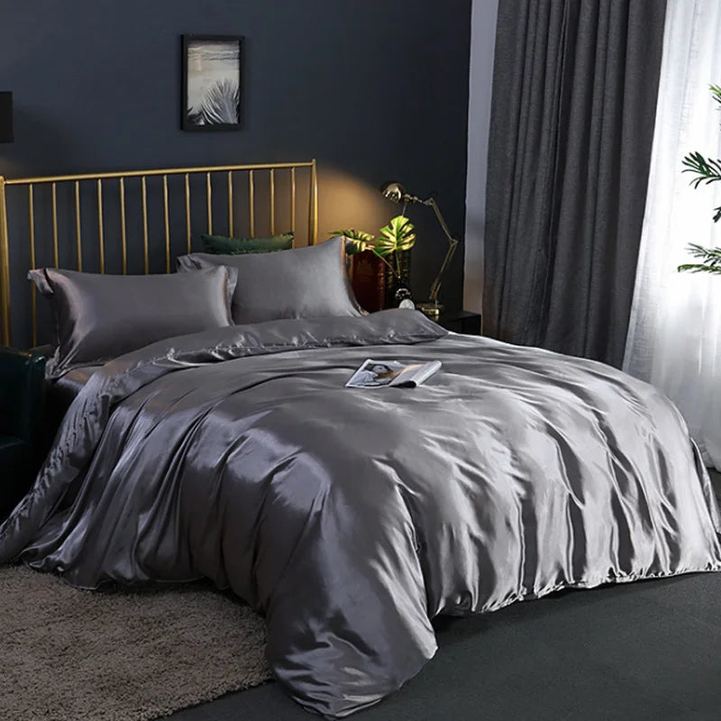 A Silver Grey bedding set on a bed in a bedroom with a gold headboard and dark walls.