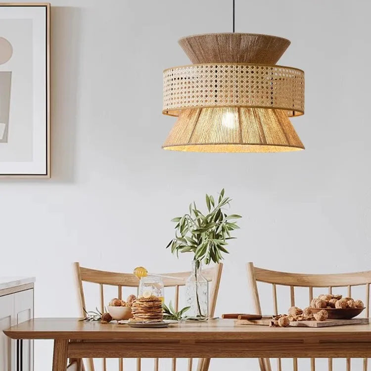 Woven pendant light hanging above a dining table with chairs and decor.