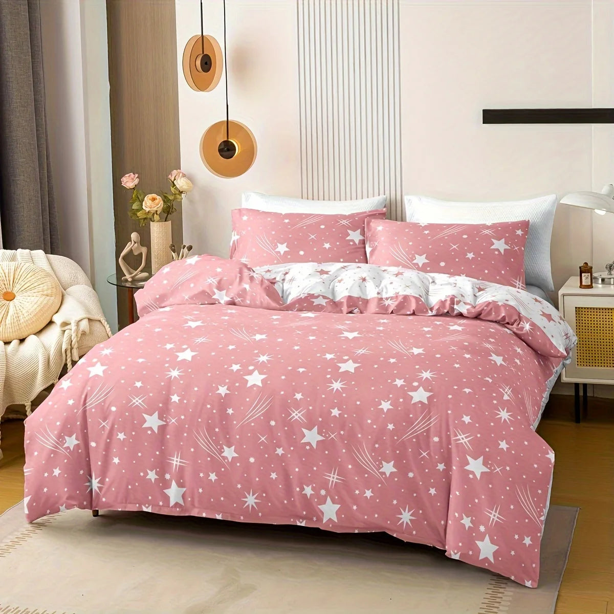 Pink star-patterned bedding set on a bed in a bedroom.