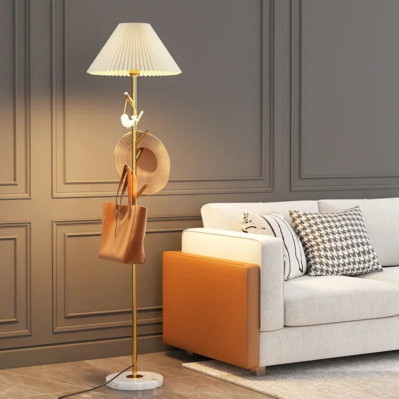 Gold metal floor lamp with marble base and integrated hooks