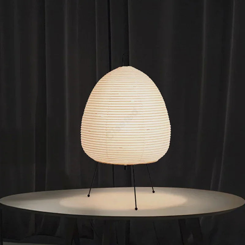 Japanese style lamp with a textured white shade on a black background