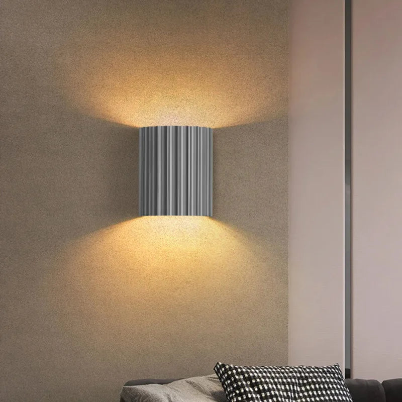 White ribbed resin wall lamp with smooth fluted texture.