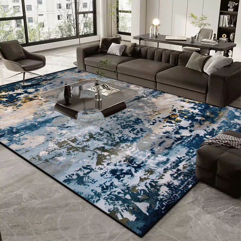Living room with a blue and gray patterned rug, dark sofa, and coffee table.
