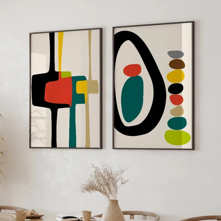 Two abstract art pieces with colorful geometric shapes on a wall.