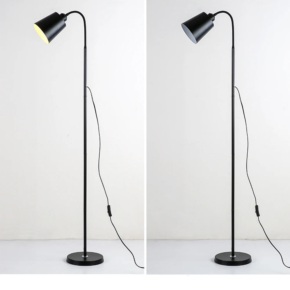 Black floor lamp with adjustable head on a white background
