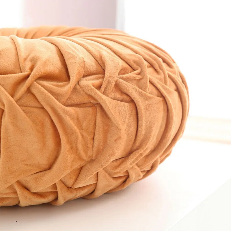 Close-up of a textured peach-coloured cushion on a light background