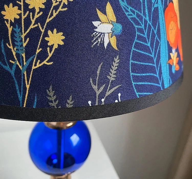 Close-up of a floral fabric lampshade with soft ambient glow