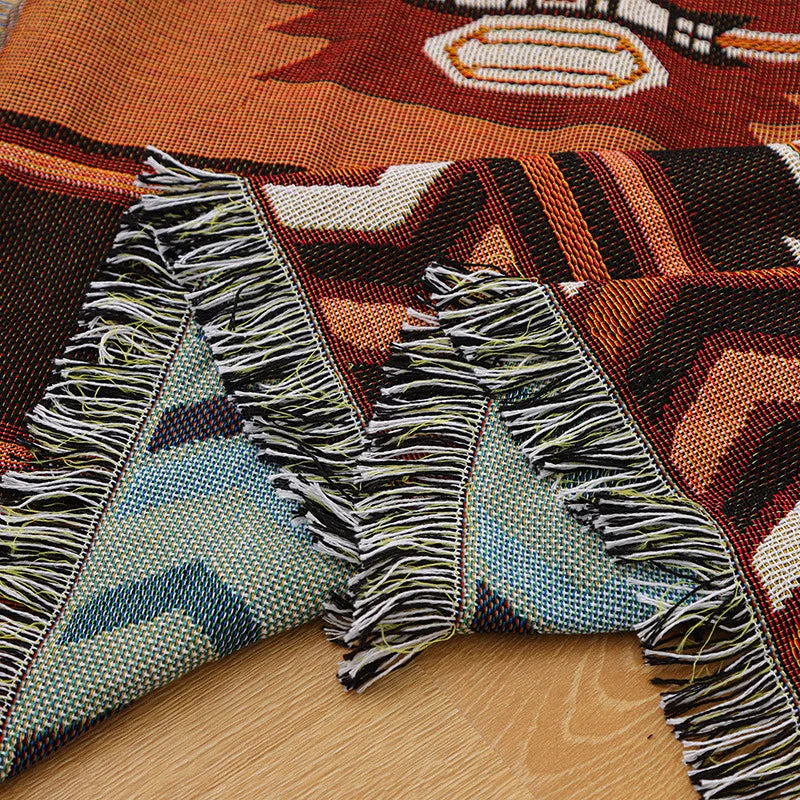 Close-up of a patterned rug with fringes on a wooden floor