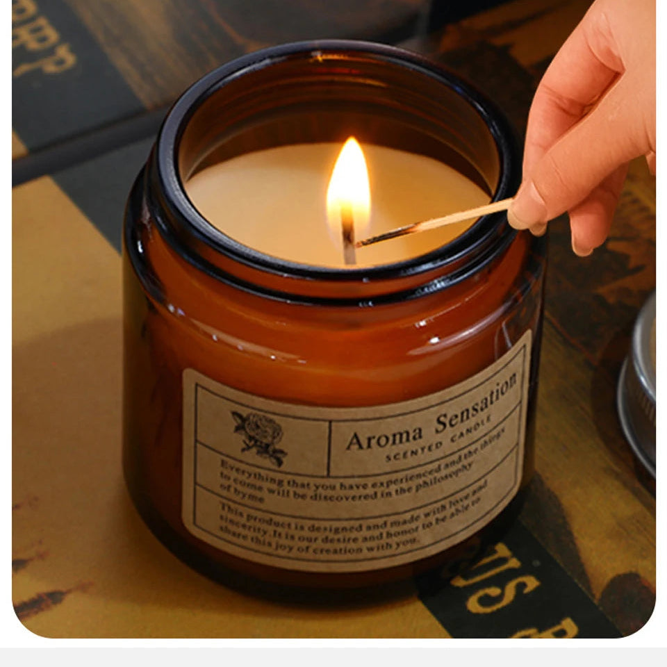 Candle being lit with a match, labeled 'Aroma Sensations', on a surface.