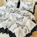 A full view of the Monarch Butterfly duvet set featuring a white base with large black-and-grey butterfly sketches and deep black ruffled trim.