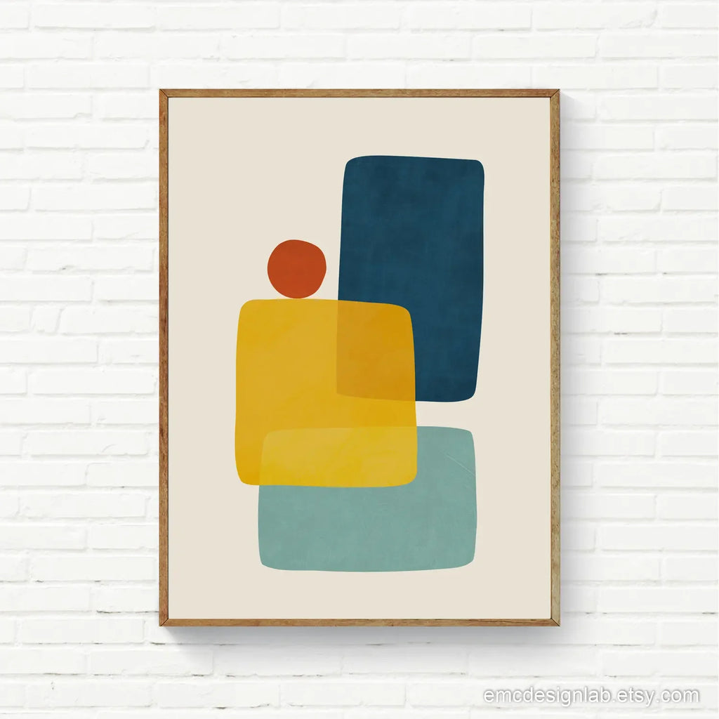 Framed abstract art print with colorful shapes on a white brick wall.