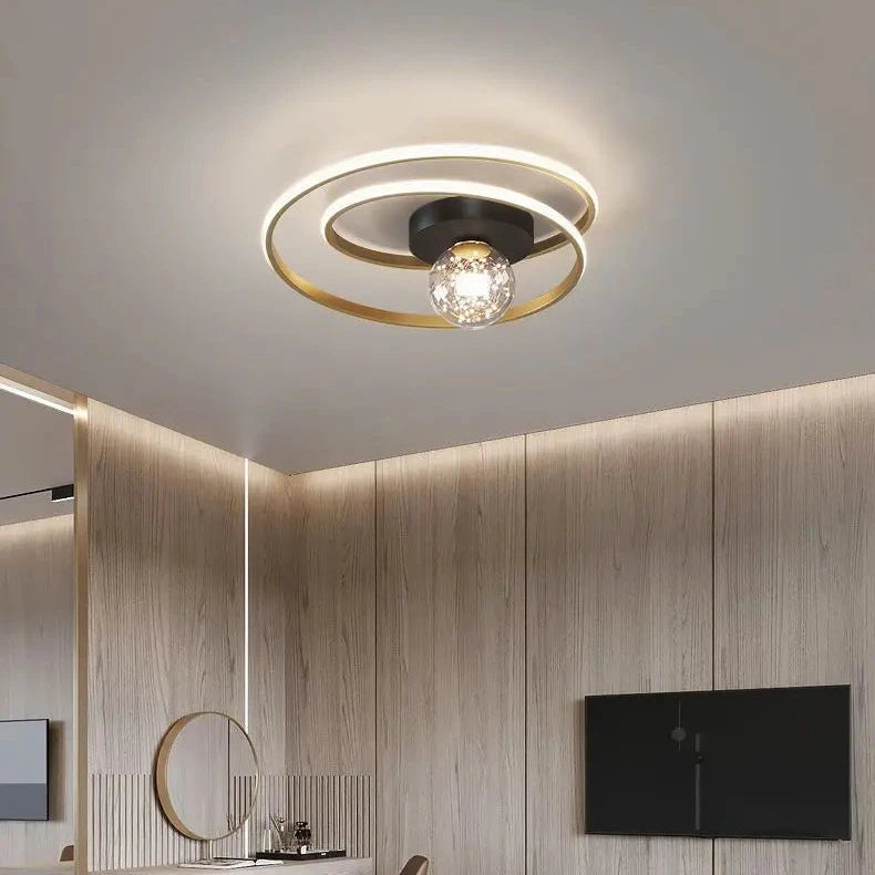 Close-up of black double-spiral LED ceiling light with textured amber glass globe against a white ceiling