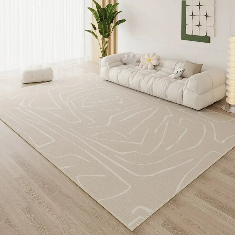 Large cream area rug with tonal abstract line print in a bright Scandinavian-style living room with white cloud sofa