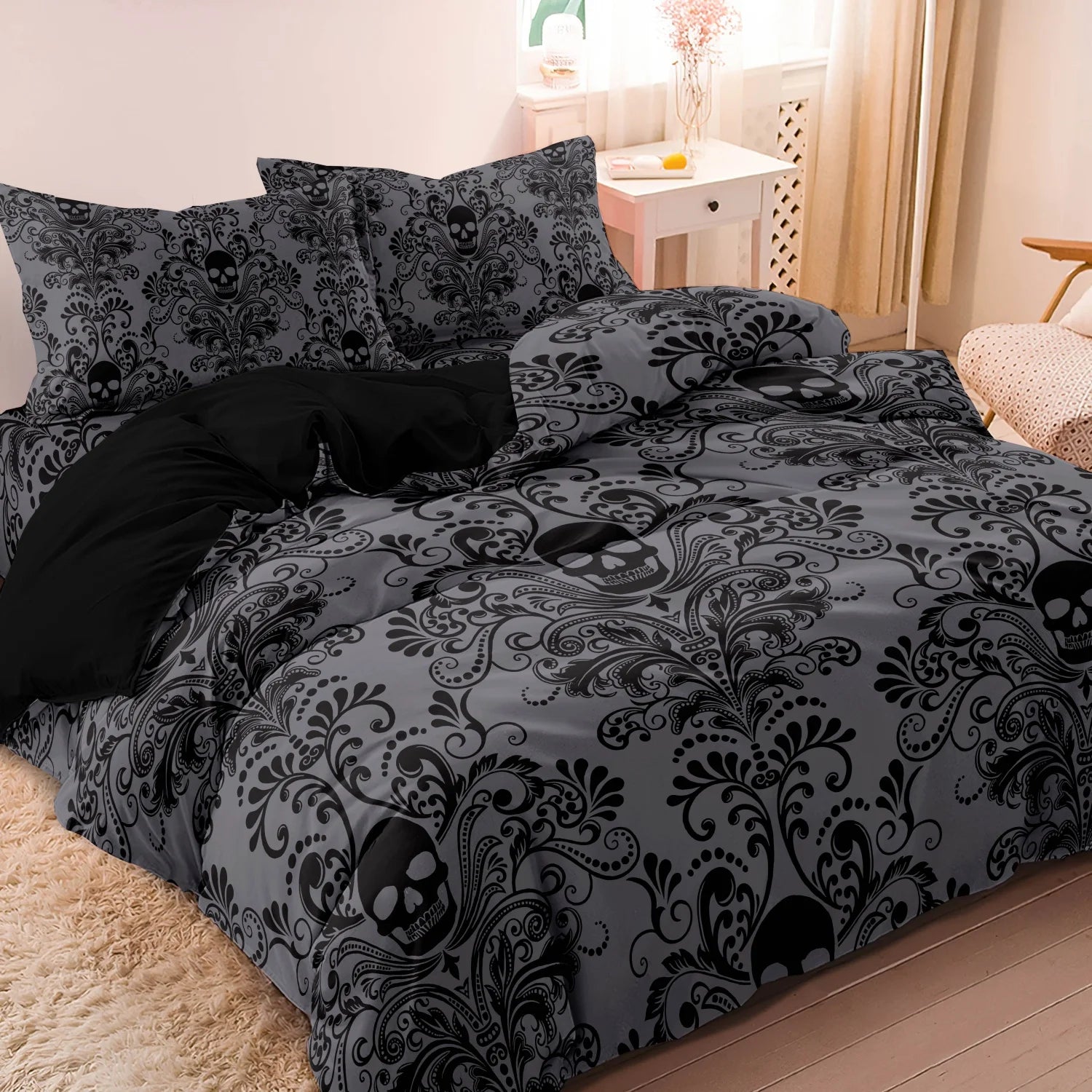 Charcoal grey skull print duvet cover set styled on a bed with matching pillowcases
