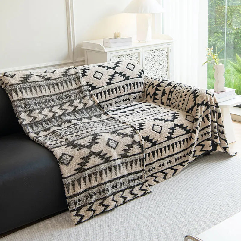 A warm beige throw over a sofa.