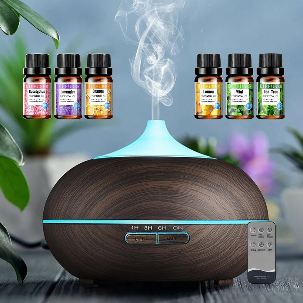 Wooden diffuser with essential oil bottles and smoke on a blurred natural background