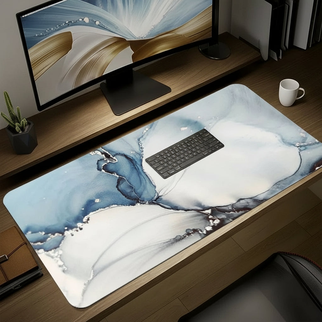 Desk setup with a large decorative mouse pad featuring abstract designs.