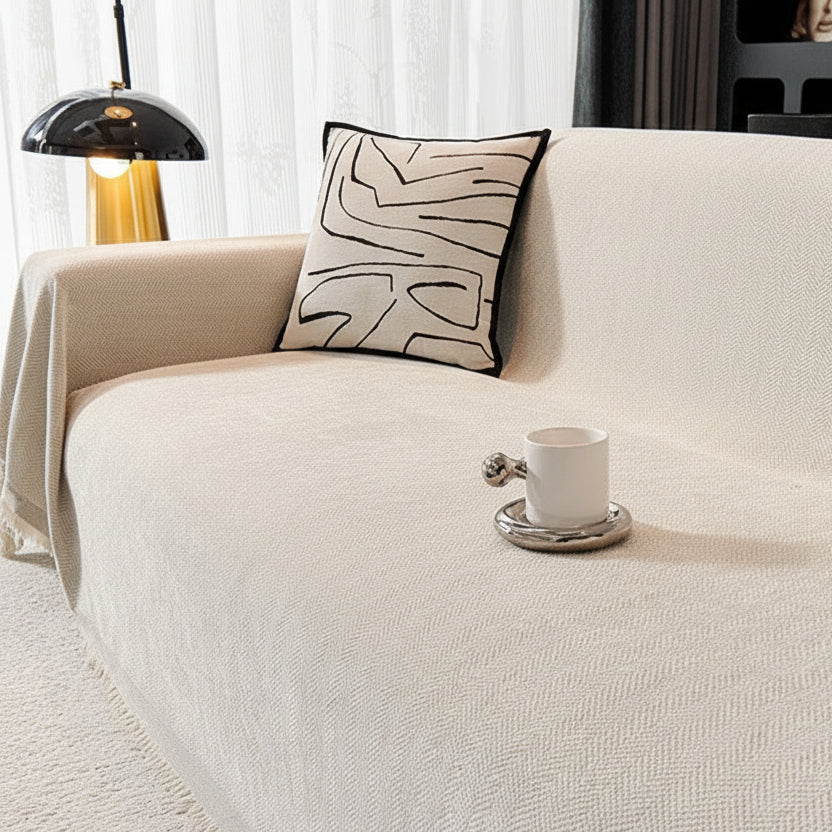 Cream Ivory textured sofa cover featuring a classic herringbone pattern and tassel edges.