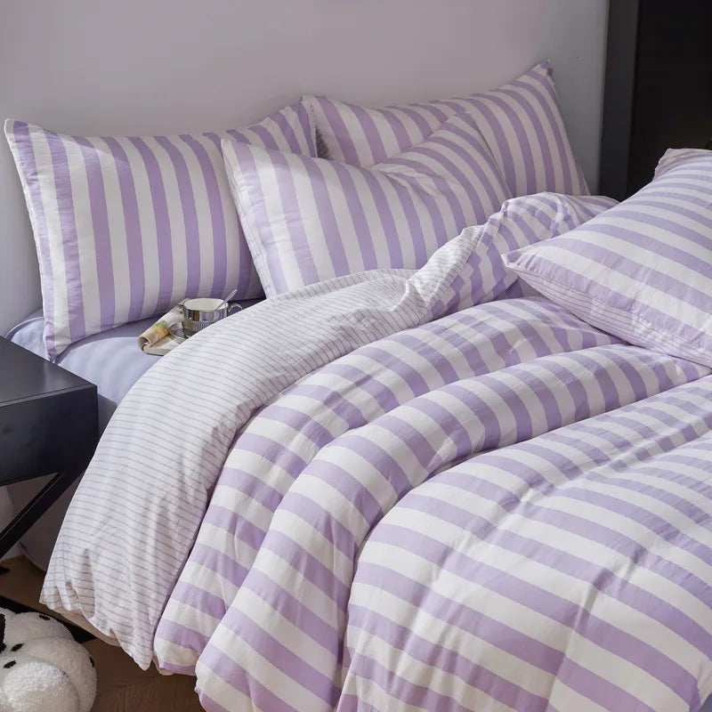 Lavender and white striped Polyester bedding set styled in a bright bedroom