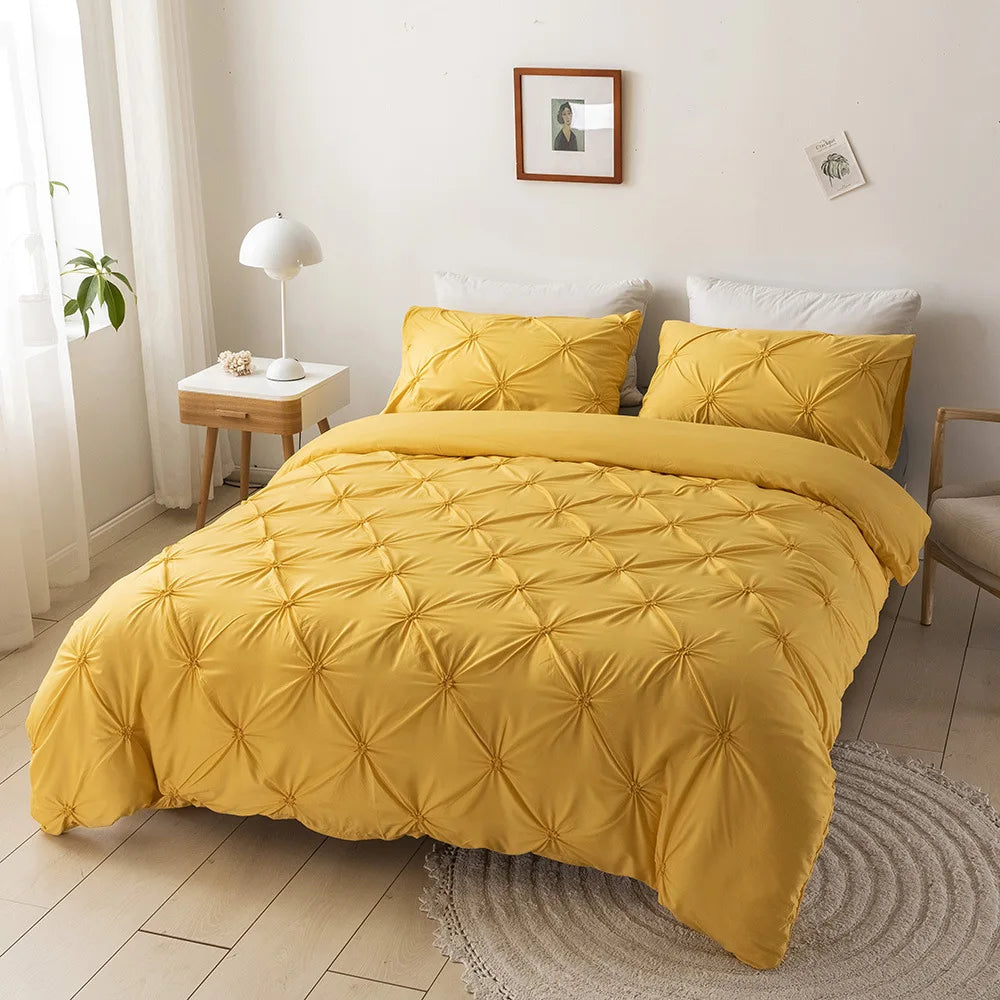 Yellow 3D pinch pleated duvet cover set styled in a light bedroom with white pillows.