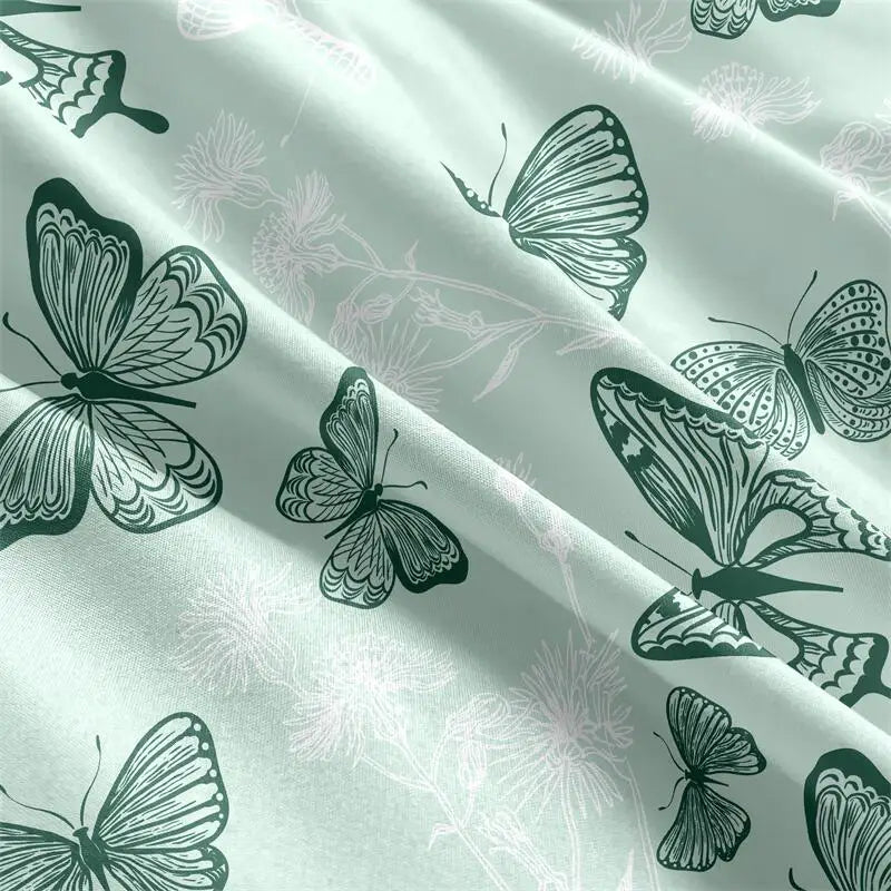 Sage-green butterfly-print duvet cover set with matching pillowcases in a styled bedroom.