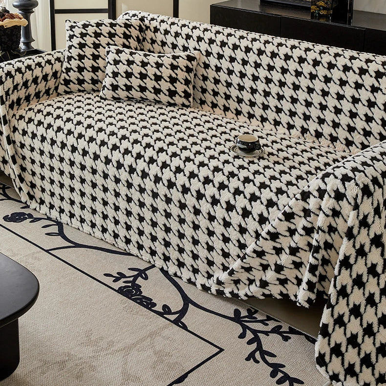Black and white houndstooth patterned sofa in a living room setting.