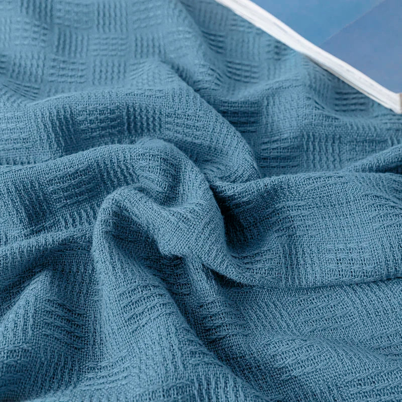 Close-up of textured blue fabric blanket.