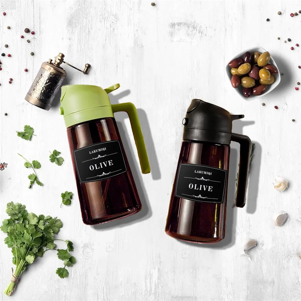 Two olive oil dispensers on a white surface with herbs and olives.