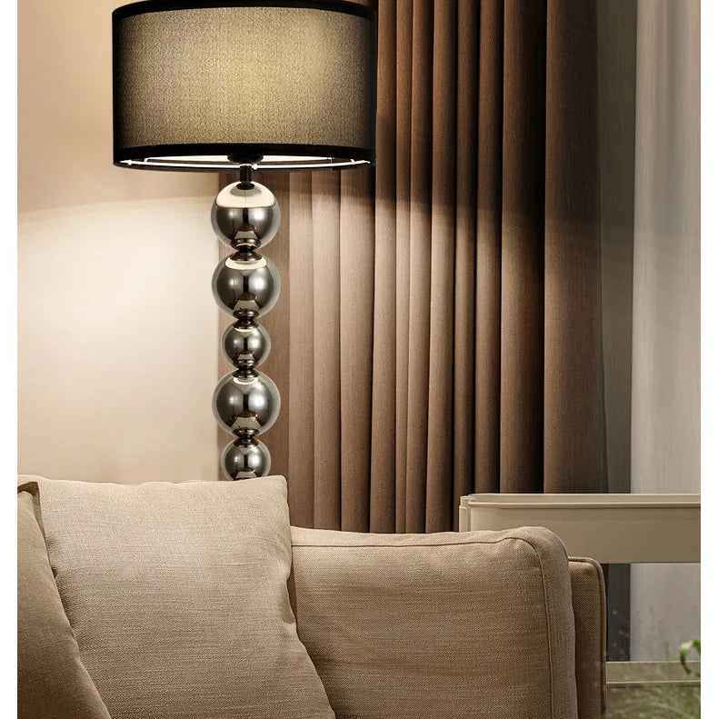 Modern Bauhaus floor lamp with chrome sphere frame in the living room corner