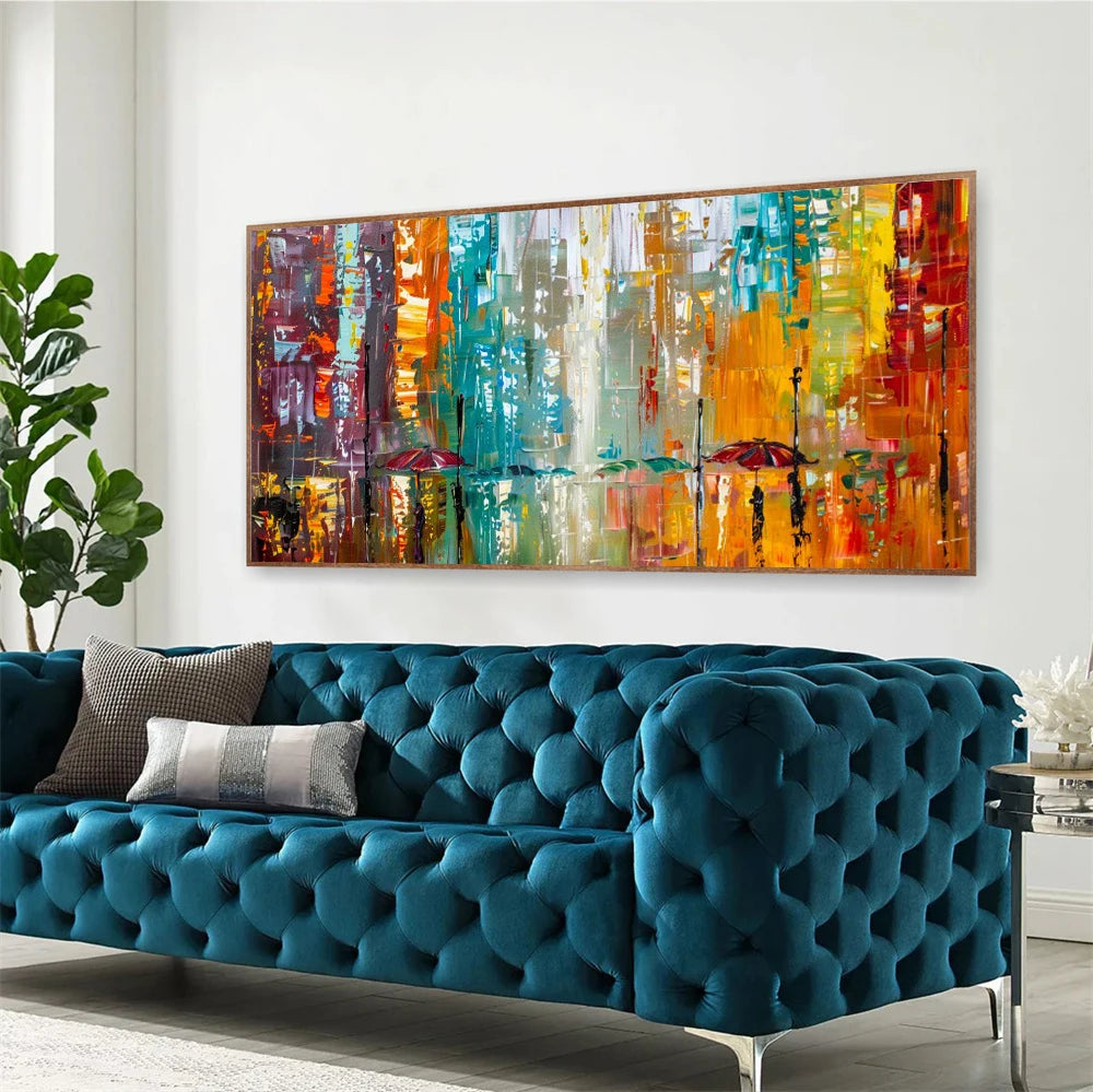 Colourful abstract painting above a blue tufted sofa in a living room.