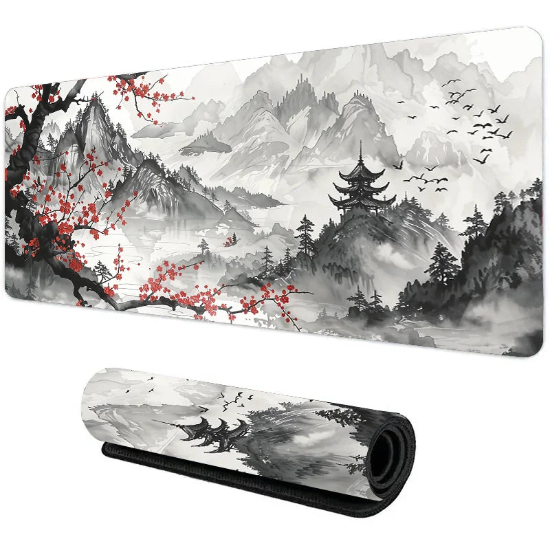 XL mouse pad with ink wash mountain landscape, red blossom branches, and flying birds, shown flat and rolled