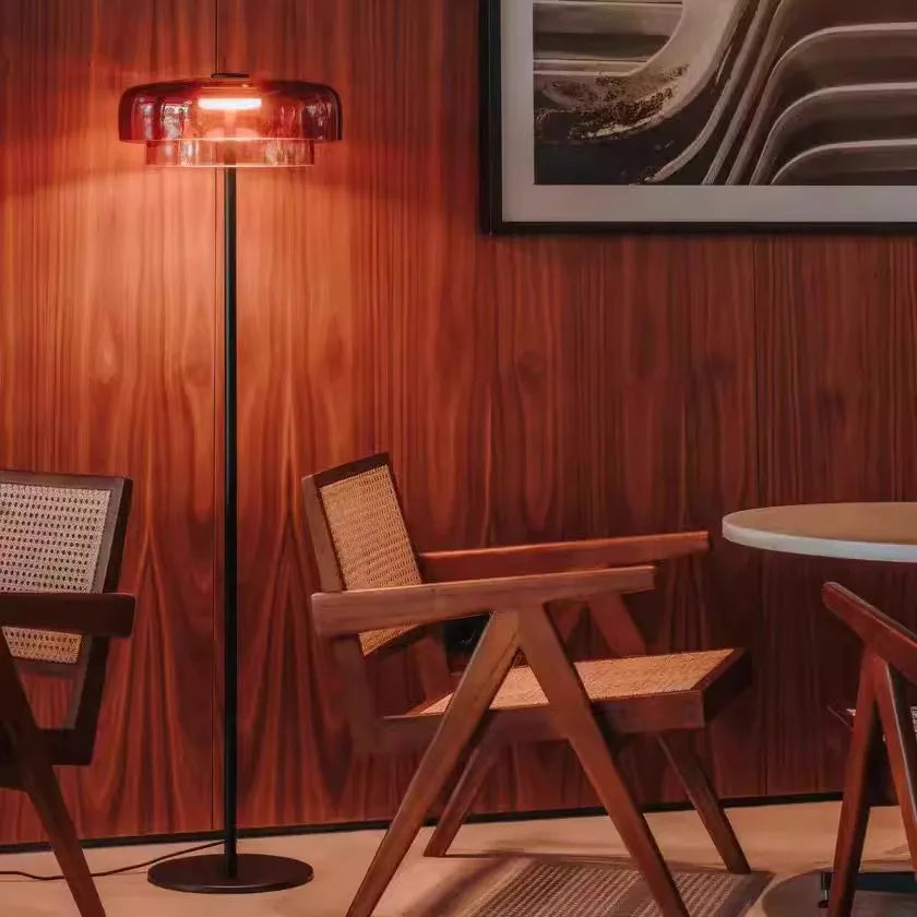 Contemporary floor light with a sunset amber glass shade and sleek gold frame for aesthetic home interiors.