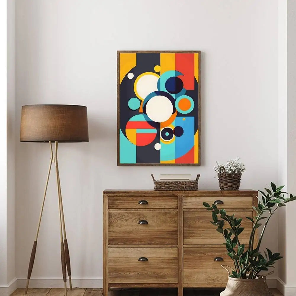 Wooden dresser with a colorful abstract painting above it, a floor lamp to the left, and a plant on the right.