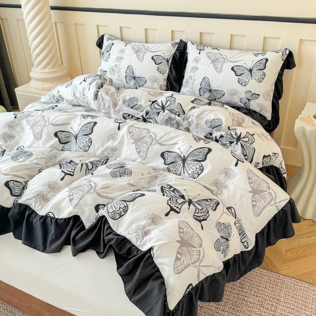 Macro view of the butterfly print on white twill fabric, emphasising the fine line-work and the soft, matte finish of the 110gsm material.