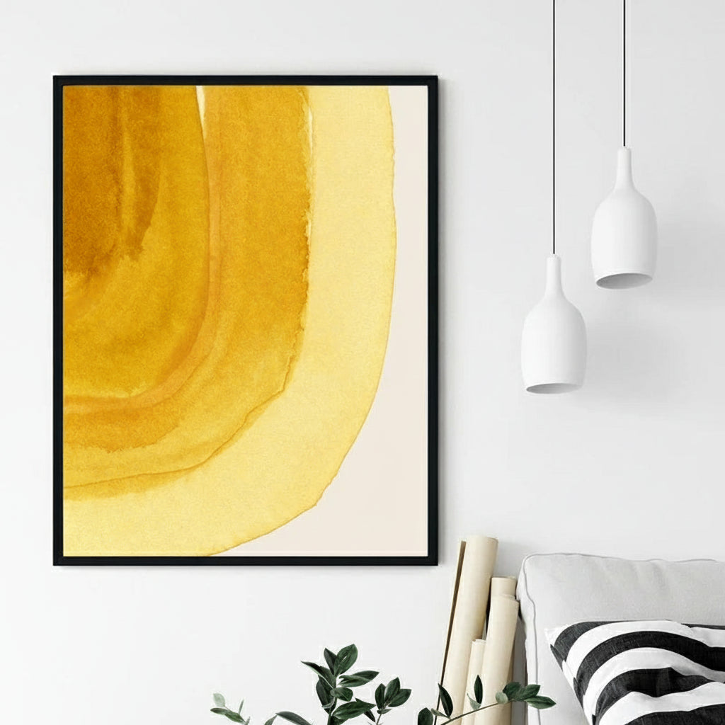 Framed abstract art print with a yellow design on a white wall above a bed.