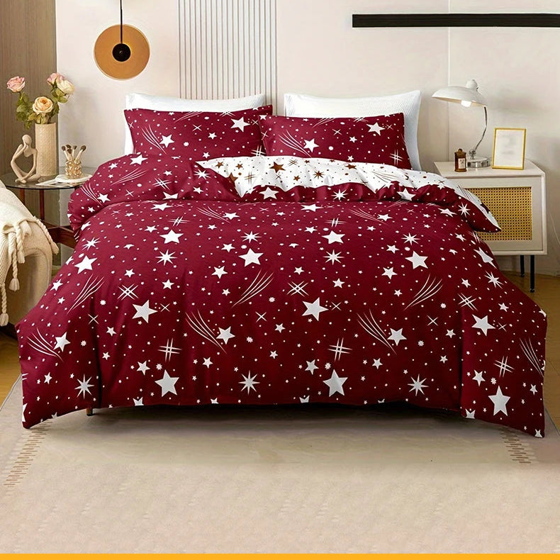 Red star-patterned bedding set on a bed in a bedroom.