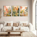 3-piece floral canvas print set styled above a cream sofa in soft peach, sage, beige, and golden tones