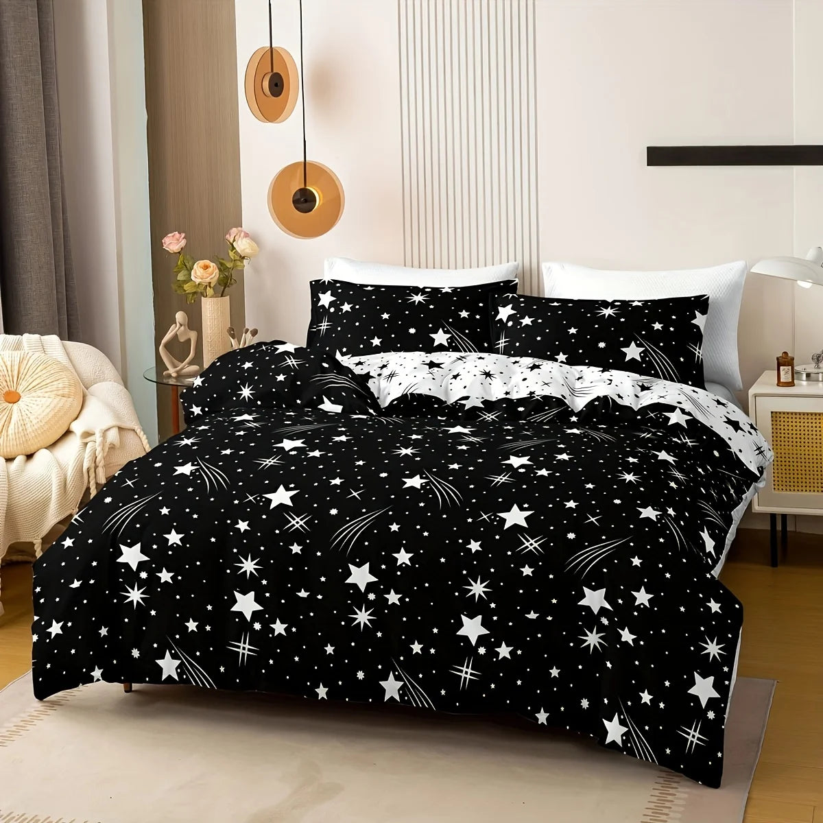 Black and white star-patterned bedding set on a bed in a bedroom.