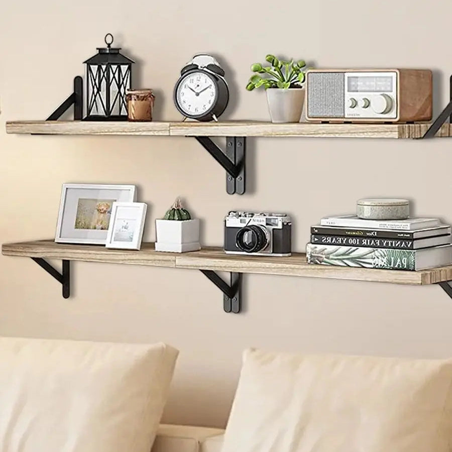 Wooden shelves with decorative items against a beige wall, with a couch in the foreground.