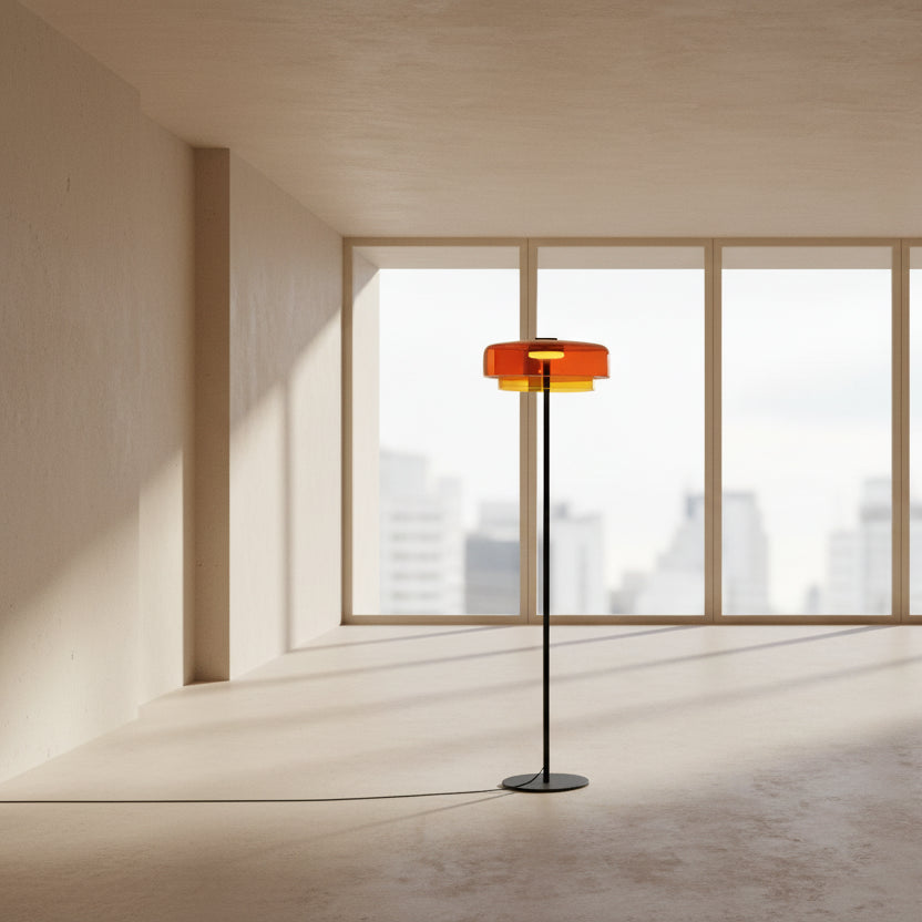 Contemporary floor light with a sunset amber glass shade and sleek gold frame for aesthetic home interiors.